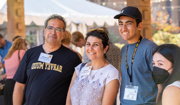 Harvey Mudd student standing with parents.